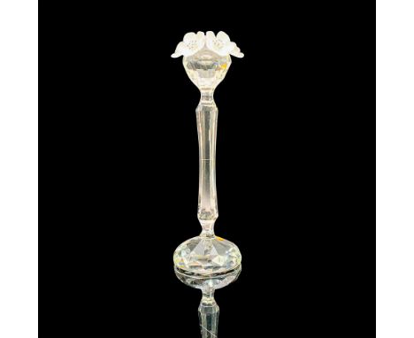 A clear crystal narrow candle holder with a round base and topped with decorative frosted flowers. Swarovski backstamp. This 