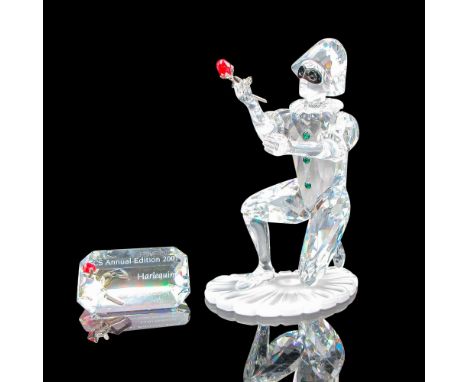 Third piece of the Masquerade trilogy. Clear crystal faceted figural with black crystal mask, holding red crystal rose. Inclu
