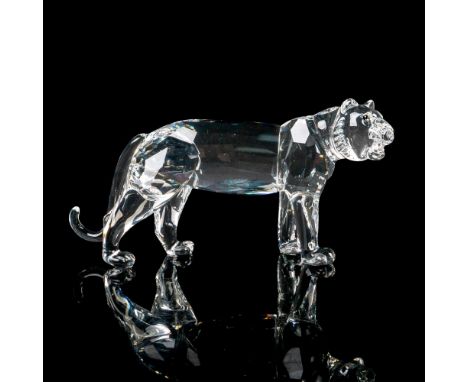 Features a clear crystal tiger with green accented eyes. Swarovski etched backstamp. This item has its original box. Box meas