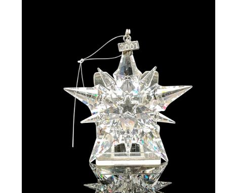 Clear faceted crystal annual ornament created with 10-pointed star design. Blue satin ribbon included for hanging. Swarovski 