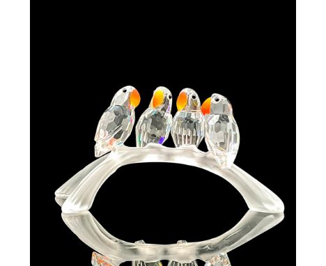 Four clear crystal birds with bright colored beaks sitting on a branch. Swarovski backstamp. This item has its original box. 