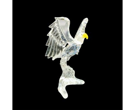 The bald eagle is made from faceted clear and frosted smooth crystal with a light topaz beak and blue crystal eyes. The bird 