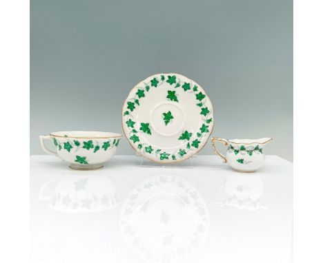 Tea set consisting of a teacup, saucer designed with green grape leaves and ivy and creamer designed in clover pattern. Heren