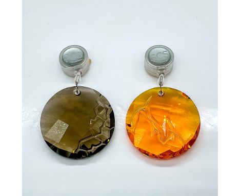 This pair of Swarovski Crystal Window Ornaments includes the Earth suncatcher in smoky quartz crystal and the Fire suncatcher