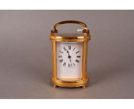 An elliptic brass French carriage clock, with Roman dial, and platform escapement 13 cm H Runs when wound - We offer no warra