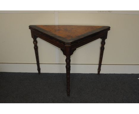 A late Victorian or Edwardian period card table, with triangular folding top in mixed woods, AF, on turned supports 