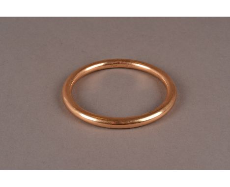 An Edwardian 15ct gold arm bangle, the plain circular bangle hallmarked Sheffield 1901, approx 28g There are surface marks co