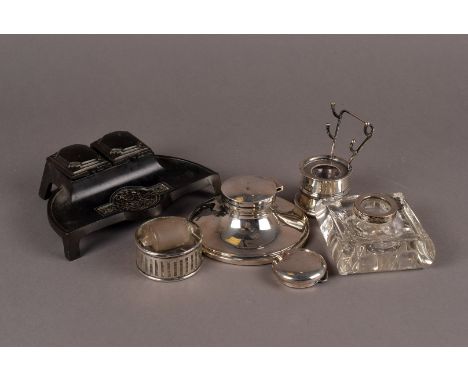 A group of four silver desk related items, including a capstan inkwell, a glass and silver capstan inkwell, damaged lid, a gl