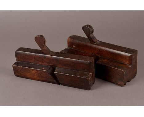 A large collection of vintage moulding planes, mostly made from hardwoods together with a selection of plough and other cutte