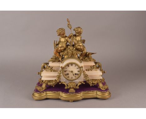 A French alabaster and gilt mantle clock, the central circular dial with Roman numerals, with cherub decoration to top, on sc