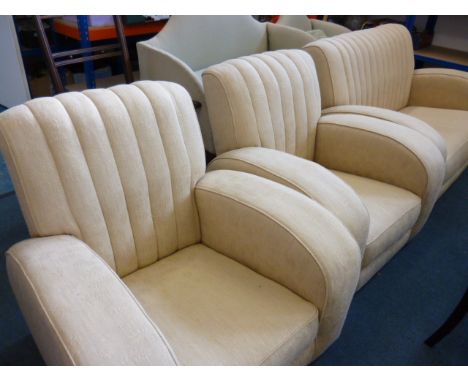 An Art Deco cream upholstered suite, comprising a two seat sofa and two arm chairs (3) 