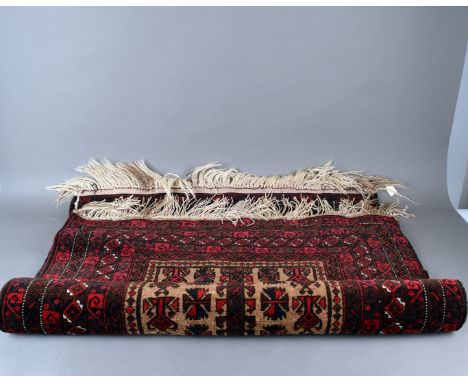 A African "Baraka" rug, 148cm x 89cm red ground with borders,  light brown central block design and tassel end. 