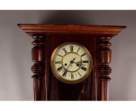 A Gustaf Becker Wall Clock, in stained beech and walnut case, with shell pediment, cream dial with roman numerals twin weight