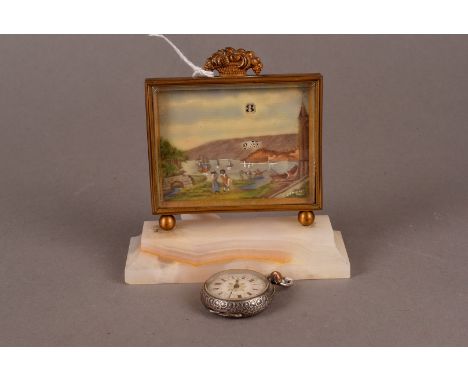 A pretty Art Deco period desk clock, having white oynx base supporting a rectangular frame picture with hour and minute apetu