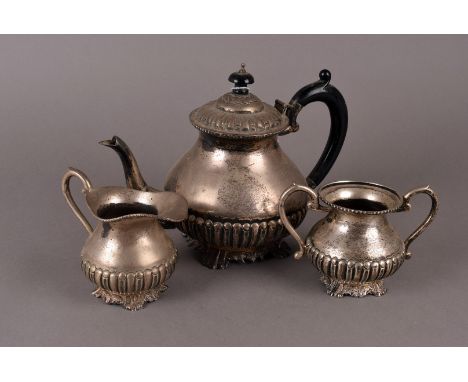 A vintage three piece silver marked tea set, with bulbous bodies having fluted lowers on ornate feet supports, marked Silver 