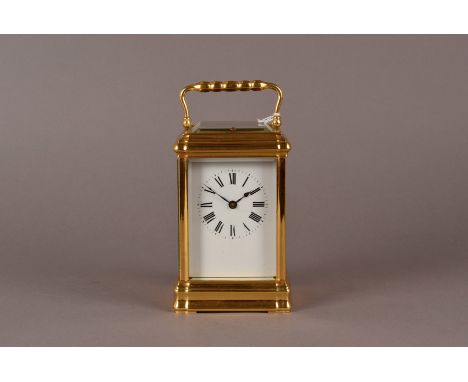 A large brass French carriage clock, with Roman dial and glazed all round, also featuring a repeater mechanism, and thickly b