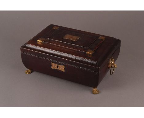 A late Victorian leather bound casket, in bulls blood finish and with brass mounts and feet, containing a case of bone and st