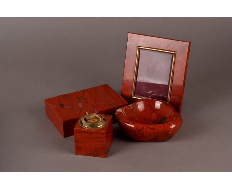 An Aspreys of London Jasperware desk set, the deep red coloured desk set comprising of a desk lighter, ashtray, cigarette box
