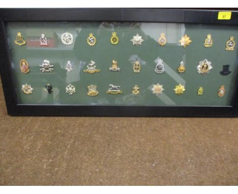 A framed collection of British Army cap badges 