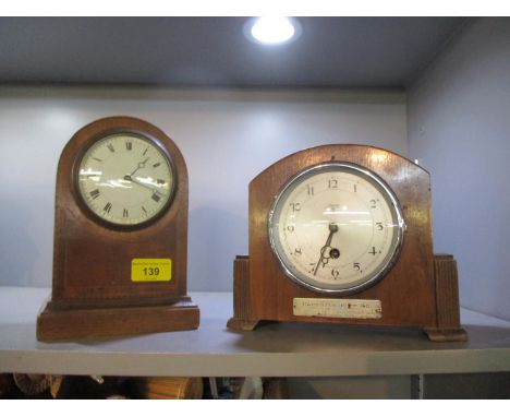 An Edwardian inlaid mahogany mantle clock on plinth base, housing a French movement, and a Newport walnut cased mantle clock 