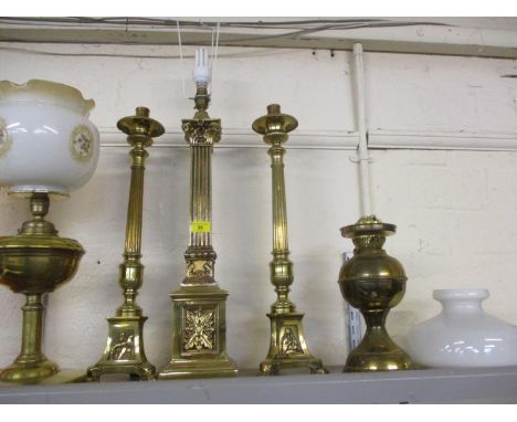 A brass column table lamp, a pair of brass column candlesticks and two oil lamps with shades A/F 
