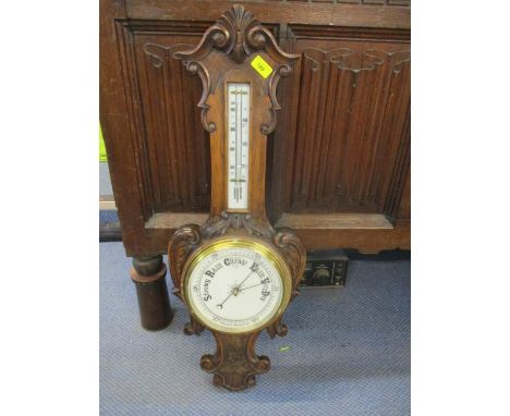 A carved oak framed Victorian wall barometer 