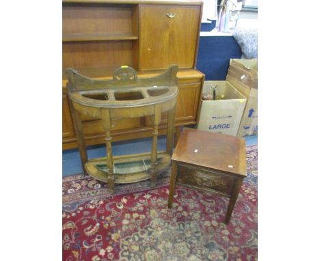 An oak demi-lune stick/umbrella stand, a low wing back armchair and a mahogany commode 