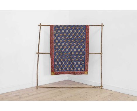 A silk embroidered tablecloth, 20th century, probably Indian, the central field worked in chain stitch with yellow and cream 