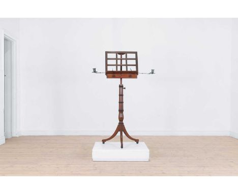 A Regency mahogany and ebonised music stand, c.1810, the adjustable stand with candle arms, on a ring-turned support descendi