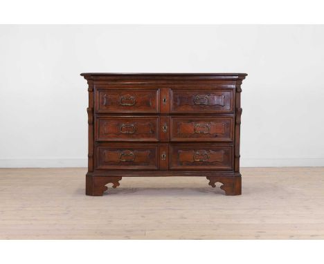 A walnut commode or cassettone, 18th century, North Italian, probably Piedmont, with a canted rectangular top above three mou