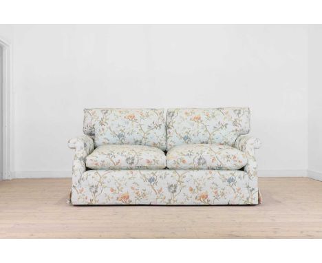 A two-seater sofa, of recent manufacture, the upholstery woven with polychrome flowers to a pale blue ground, on castors,177c
