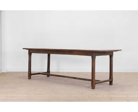 An oak refectory table, late 18th/early 19th century, with a cleated plank top, raised on chamfered square supports united by