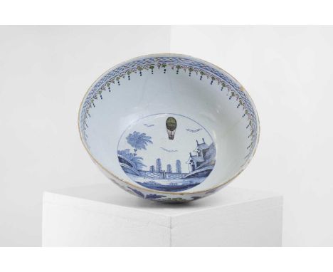 A delftware tin-glazed earthenware punchbowl, c.1785, English, London, the centre with a chinoiserie scene and a hot-air ball