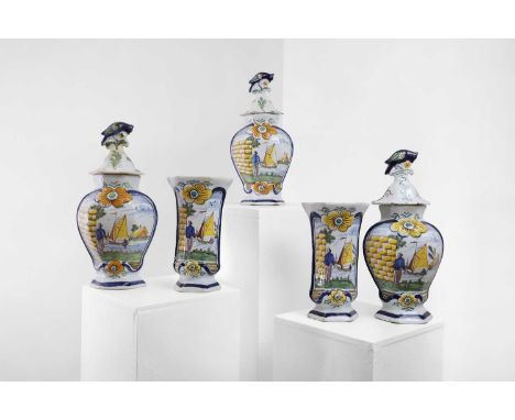 A delftware tin-glazed earthenware garniture, 19th century, comprising three baluster vases with covers and two beaker vases 