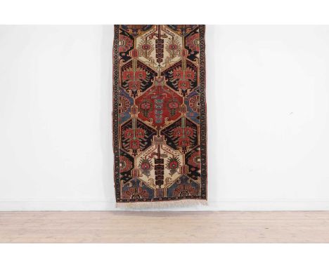 A Bakhtiari rug, first half of the 20th century, Persian, with a lattice design to a dark navy ground,173 x 89cmCondition Rep