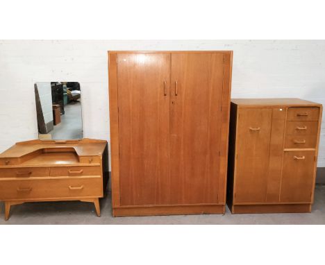 A Gomme/G-Plan Brandon mid 20th century three piece bedrooom suite in light oak comprising gents combination wardrobe with 3 