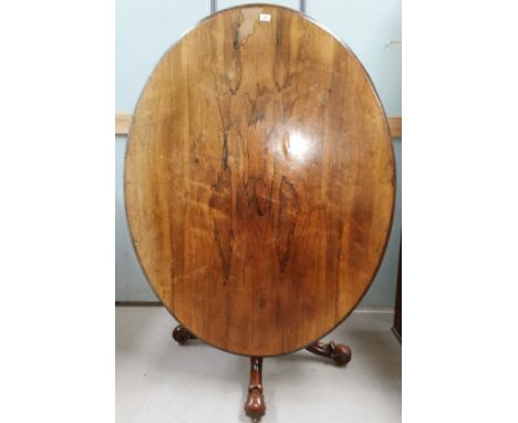 A Victorian rosewood oval looe table on turned baluster column and 4 scrolled splay feet and castors, length 54" 