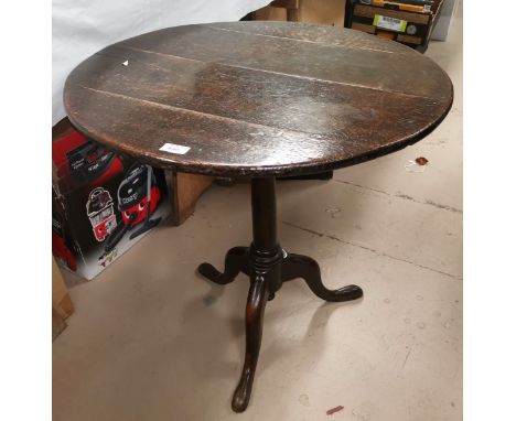 An 18th century countrymade circular tilt top occasional table on turned baluster column and 3 splay feet, width 27" 