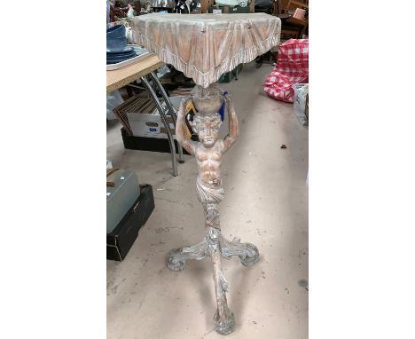A limed wood torchere on cherub column 