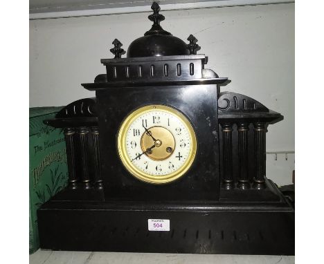 A black slate classical architectural style mantel clock with 3 pillars to each side, striking on gong, with key and pendulum