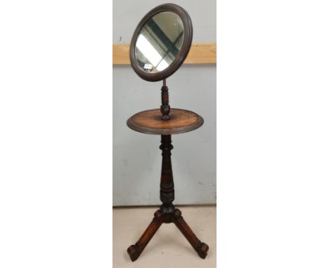 An Edwardian shaving stand with adjustable mirror and circular top, on turned column and 3 splay feet 
