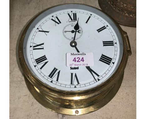 A 19th century inlaid mahogany cased mercury column barometer with level incomplete; A brass ship's clock by Sestrel 7" 