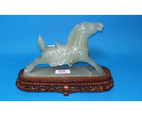 A Chinese jade coloured hardstone figure of a galloping horse, on carved hardwood base, length of horse 8" 