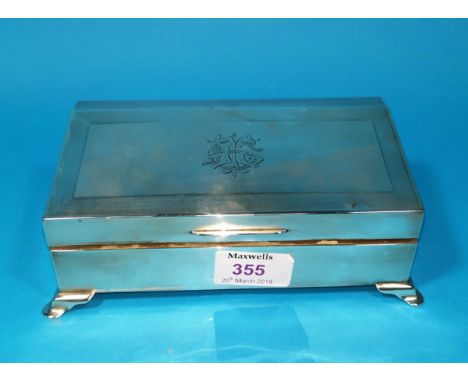 A silver cigarette box, engine turned with slope front, monogrammed, London 1924 