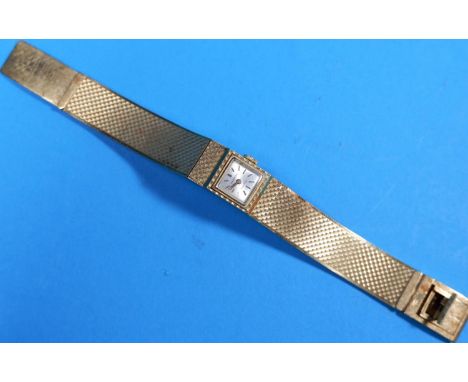 A lady's 18 carat hallmarked gold watch by Candino, on integral engine turned strap 