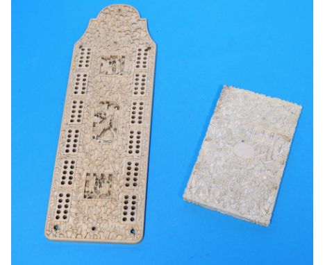 An early 20th century Chinese ivory card case, extensively carved, length 4"; a similar cribbage board