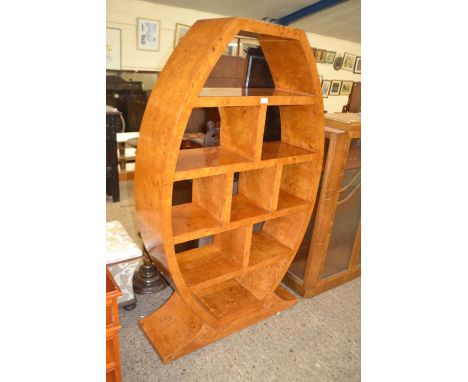 Art Deco style walnut veneered shelf unit of oval form, 161cm high