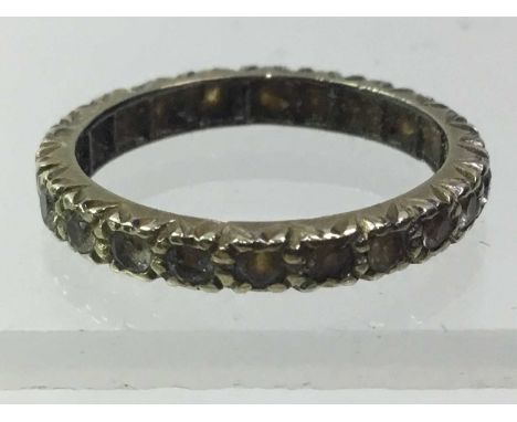 DIAMOND ETERNITY RING, with a row of round brilliant cut stones in a carved settingQty: 2.36g