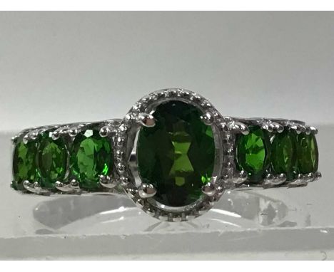 TWO CHROME DIOPSIDE RINGS AND A PAIR OF EARRINGS each in silverCondition is good, some surfaceware, the ring with three stone