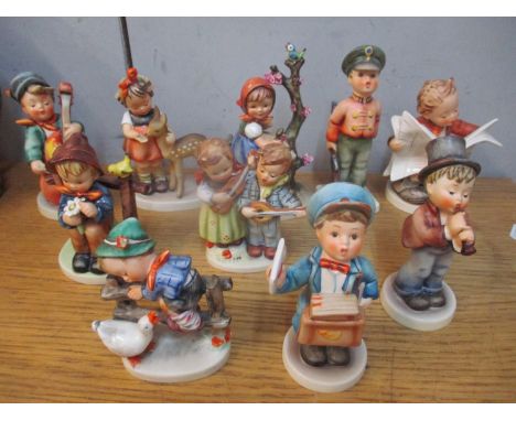 Ten Hummel figures to include one of a boy playing the cello 